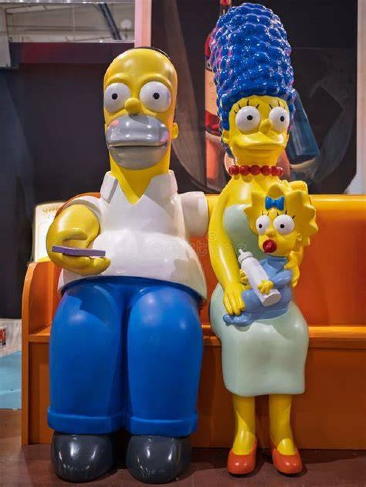 Marge and Homer are sitting at the kitchen table in The Simpsons.